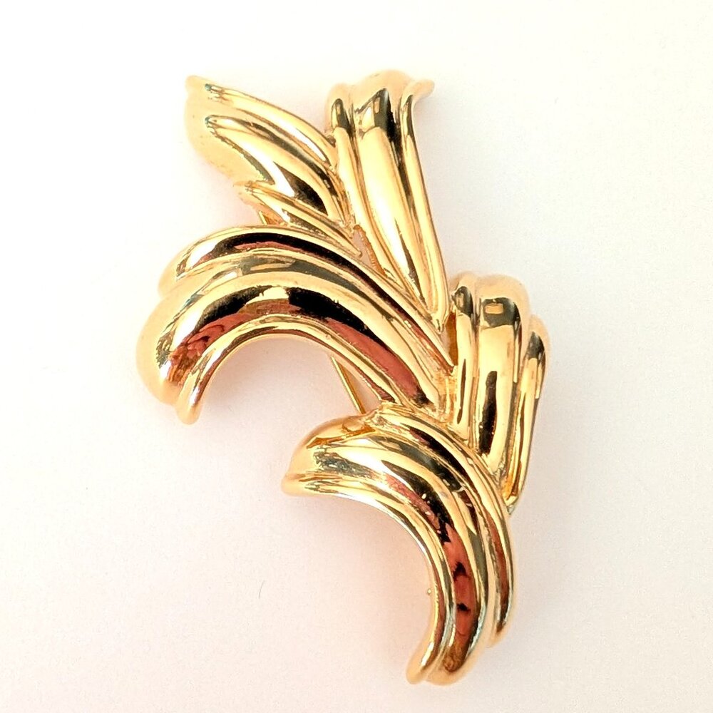Monet gold tone brooch